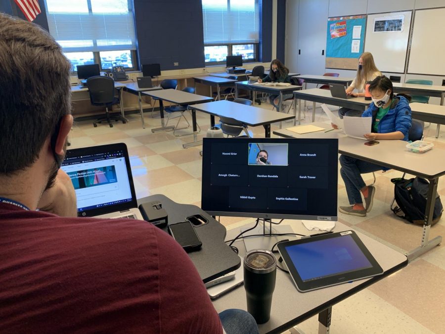 Mr. Burlingame talking with his remote and in-person students during Writing Center