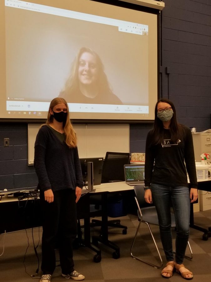 Two students meet in person while one is remote during Book Club