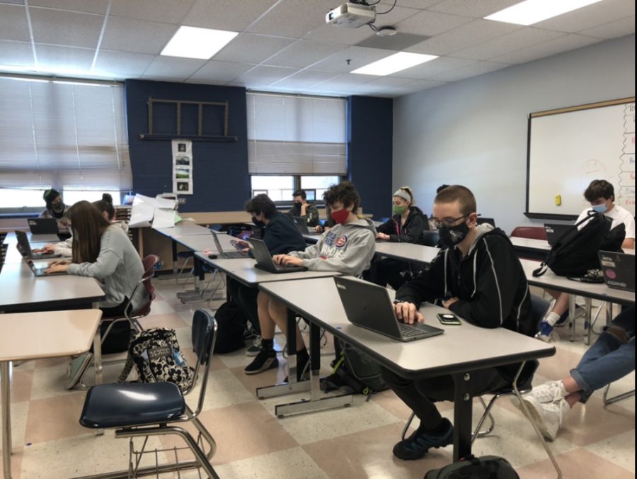 Students, spaced 3 feet apart, work on their Chromebooks