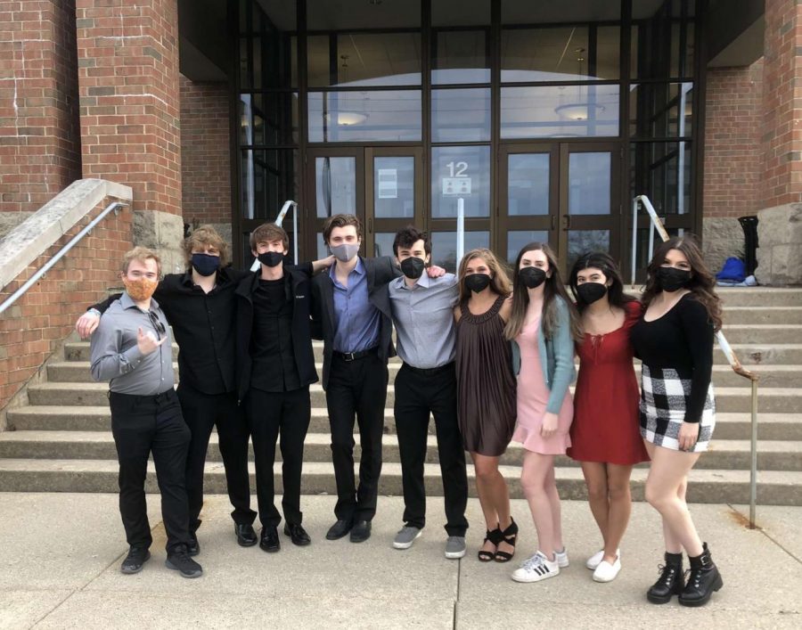 Seniors that worked in the show gather together outside in front of the auditorium.