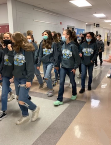 Girls cross country at their drum line send off to state