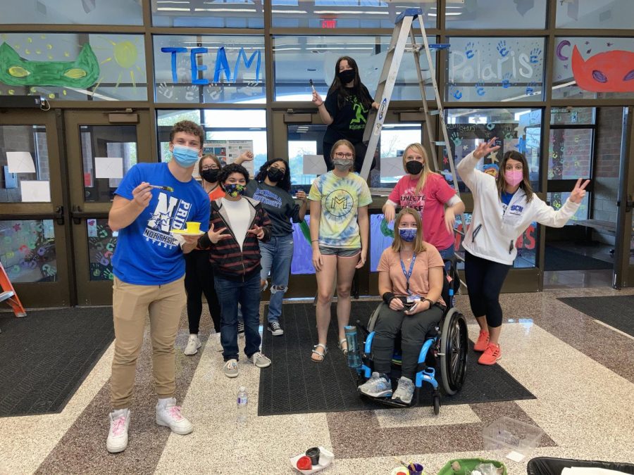 Surges painting windows with Team Polaris during Homecoming Week