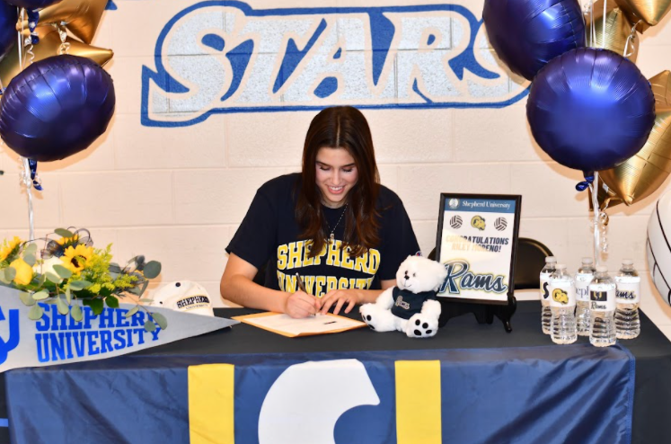 Moreno signing her National Letter of Intent for Shepherd University to play volleyball