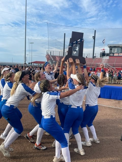 The softball team receives the state championship trophy.