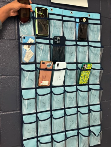 Students place their phone in the caddy as they come into class. 