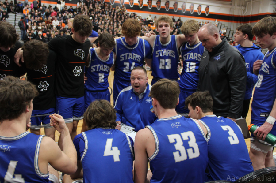 North basketball team in a huddle during match against East 