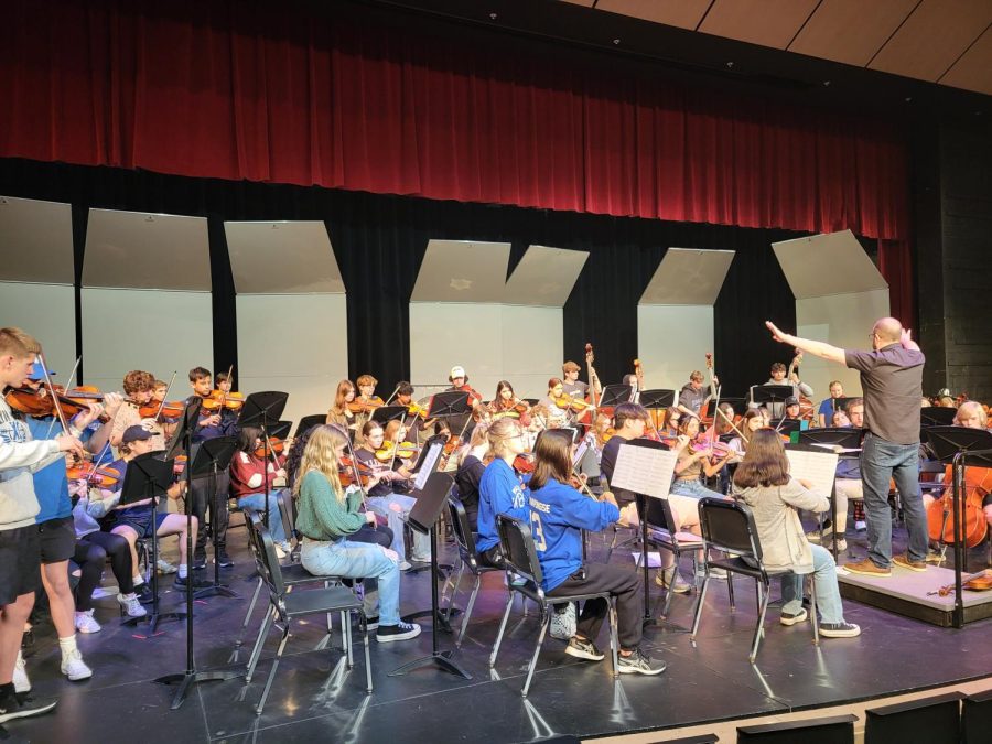 Orchestra+students+practice+at+an+after-school+rehearsal.