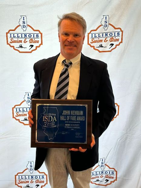 Coach Rooney holding his induction plaque