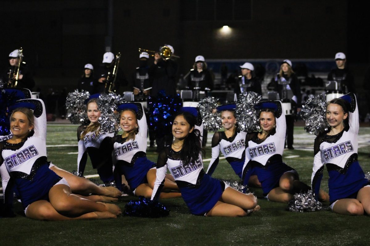 The dance team performs during a football halftime show.