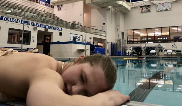 Junior Jenna Williams taking her usual nap by the pool after swimming for hours upon hours.