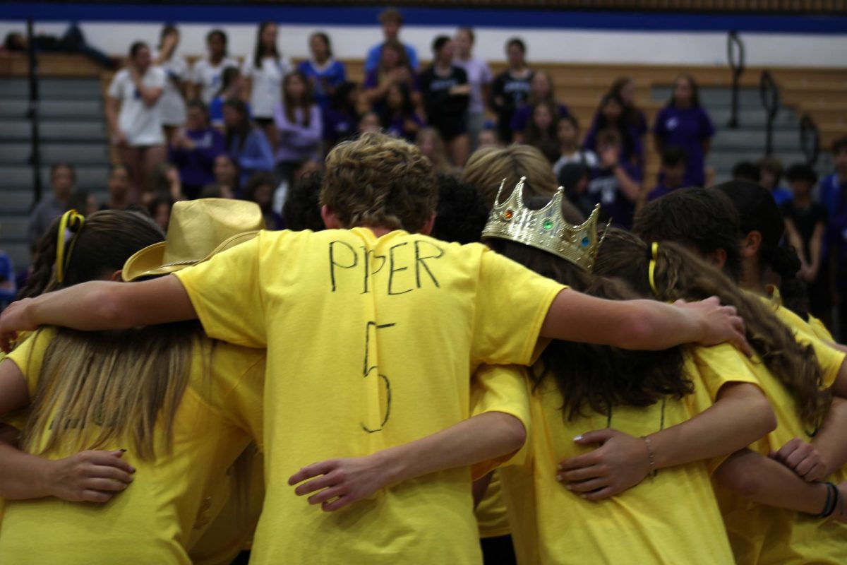 The sophomore team strategizes in a huddle.