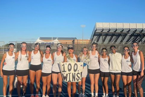 Shannon Lu poses with her teammates after celebrating her 100th win