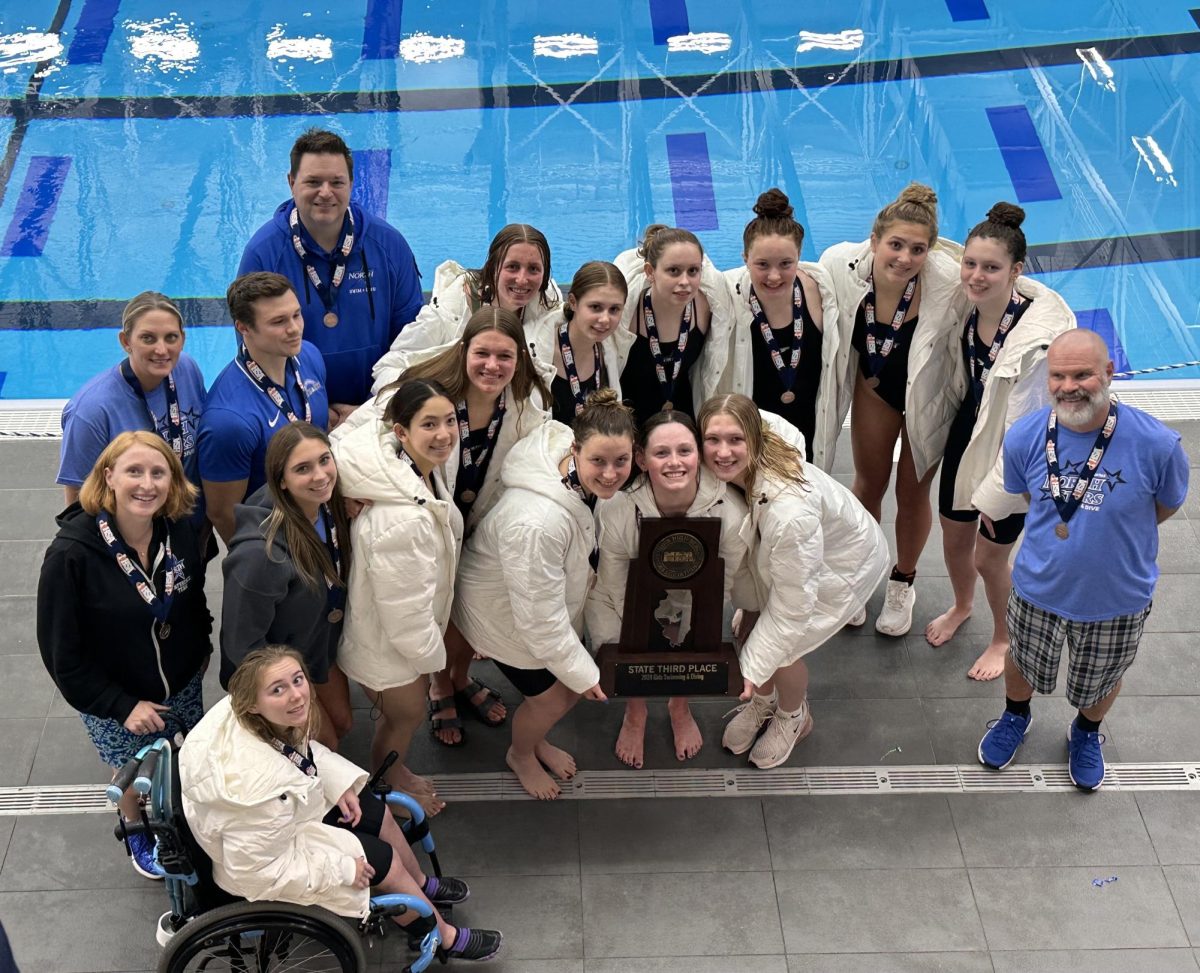 Girls swim team with their state trophy.