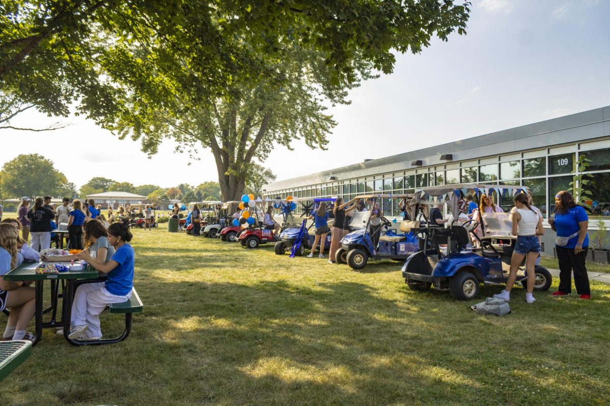 North students decorating golf carts at Compass on Thursday.