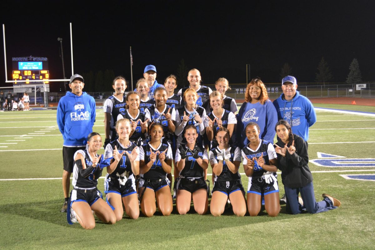 The varsity flag football team after their senior night game against Wheaton Warrenville South. Their 50-0 win officially named them DuKane Conference Champions.
