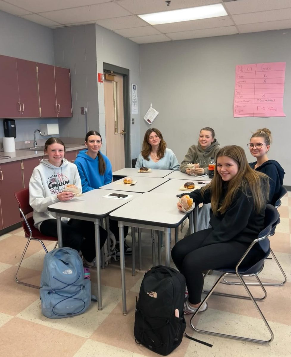 Members of Eastern European club eating snacks at one of their meetings.