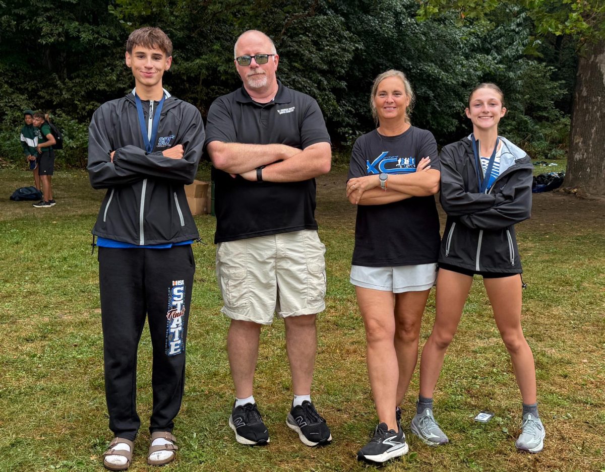 Junior Sam Hill,  Kevin Harrington, Shari Hayes, and sophomore Kara Glenn after the record breaking races