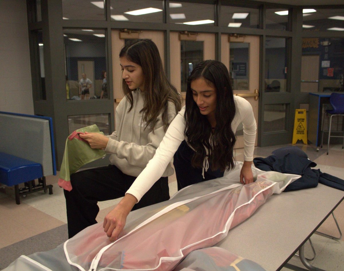 Senior Javeria Hasan and junior Aishwarya Chavda prep costumes for Saturday's Princess Superhero Breakfast. 