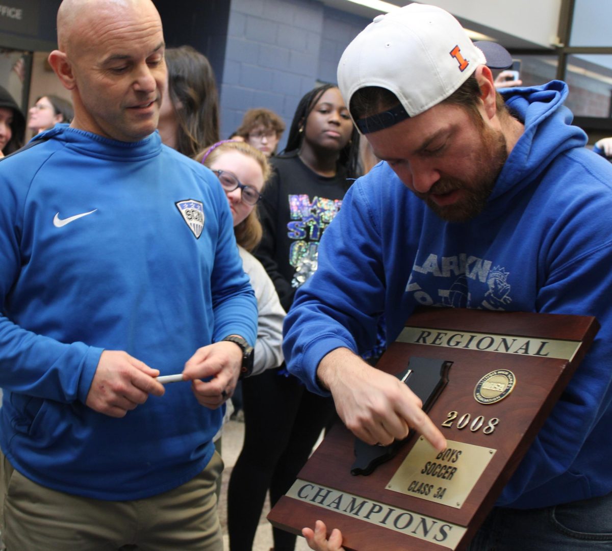 Visitor Kyle Milnamow of US 99.5 holds 2008 soccer regional plaque 