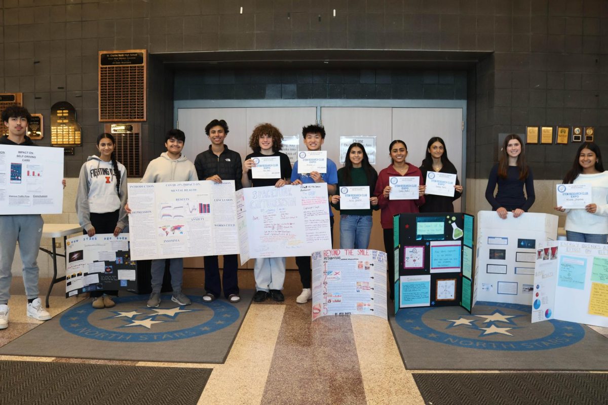 Participants in the first science fair hosted by STEM research club pose with their awards and projects.