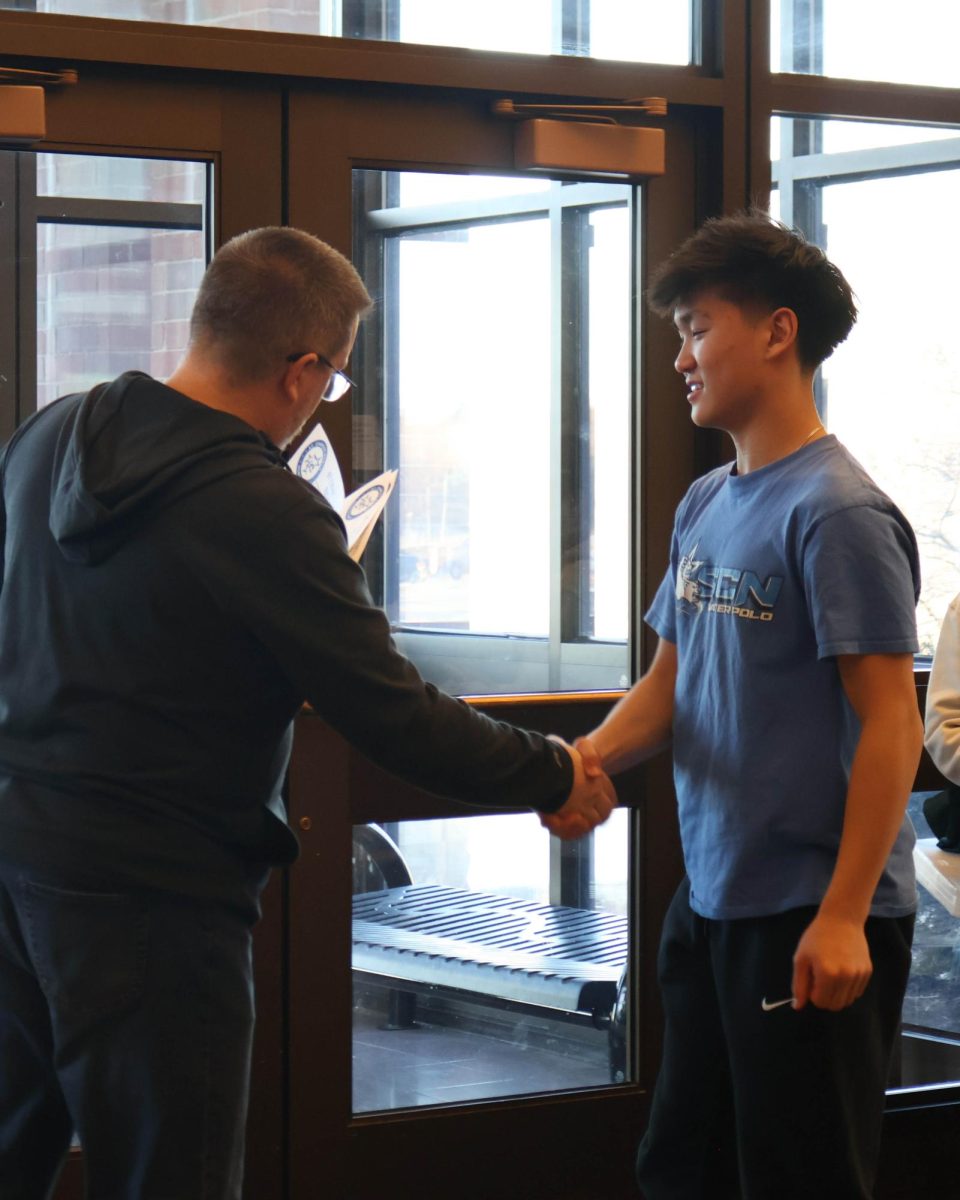 Judge Peter Gleason presenting junior Michael Li with most original award. 