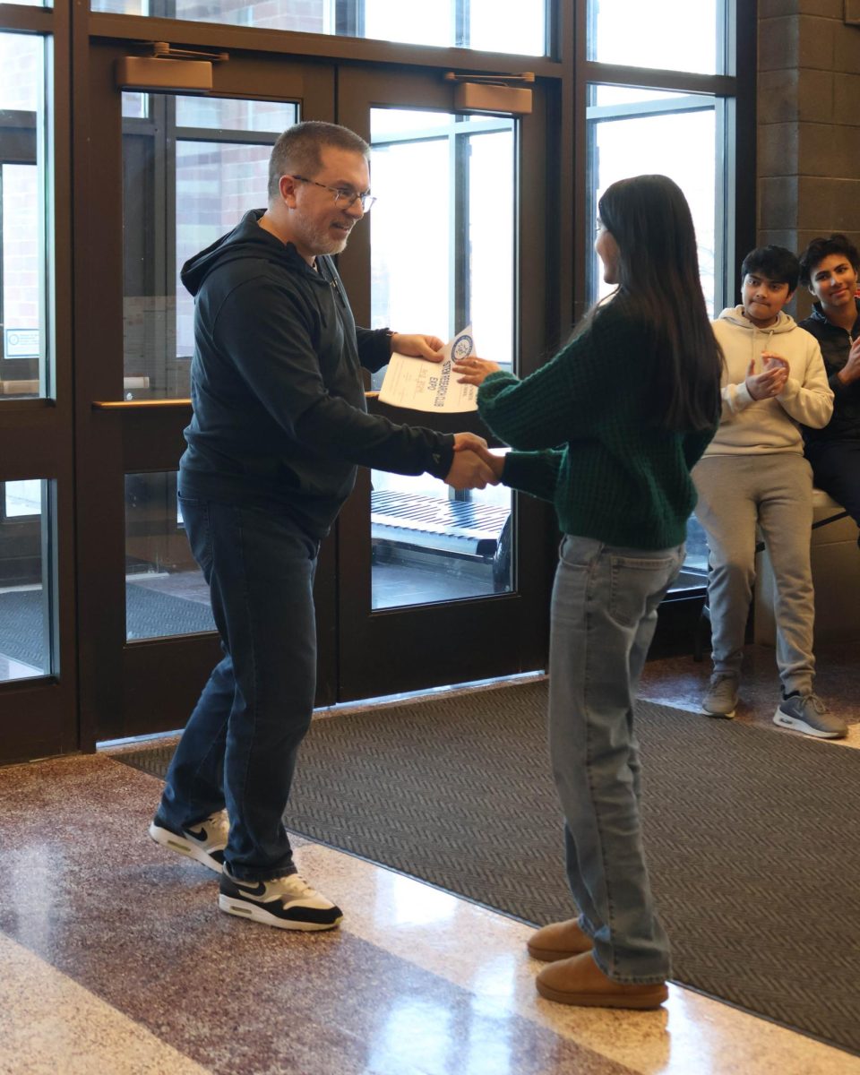 Sophomore Aria Bhate accepting first place award from Peter Gleason. 