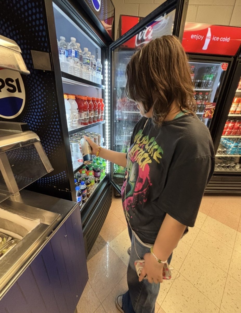Freshman Izzy Nolan grabbing a BUBBL'R drink from North's cafeteria.